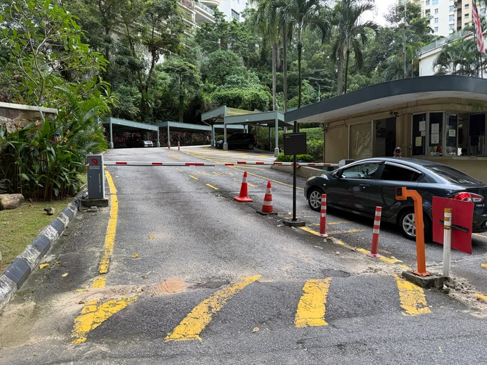 Residential condominium entrance with barrier gate managed by Gprop Systems access card system for secure vehicle access.