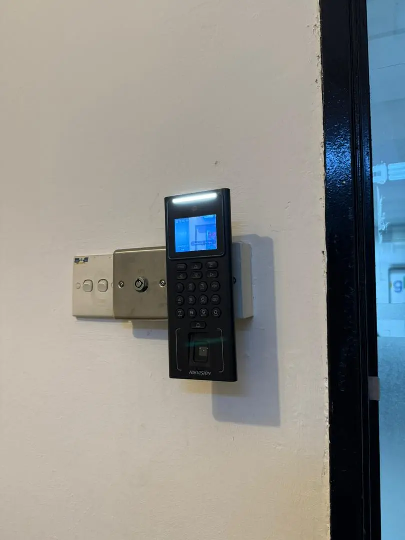 Facial recognition reader with keypad mounted on a wall for biometric property access control by Gprop Systems Malaysia.